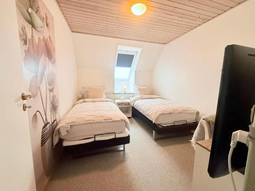 a bedroom with two beds in a room at OJ Home in Vojens