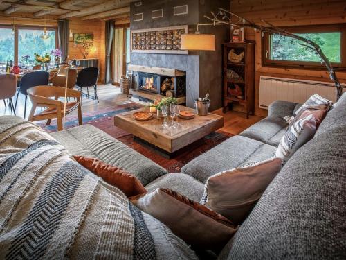 a living room with a couch and a fireplace at Chalet Bendo - OVO Network in Villarembert