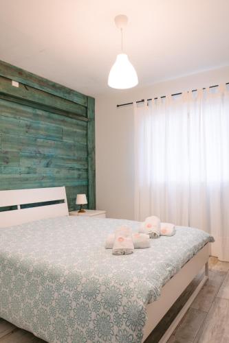 a bedroom with a bed with towels on it at A Praia- My Own Paradise T1 in Figueira da Foz