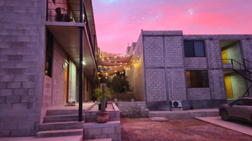 a house with a sunset in the background at Santas y Santos in Todos Santos