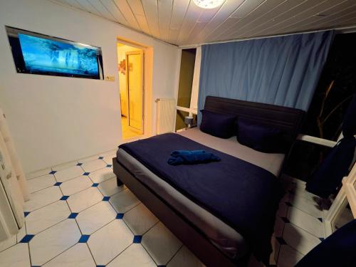a bedroom with a bed with a blue shirt on it at Villa mit Garten 4 Personen in Nuremberg