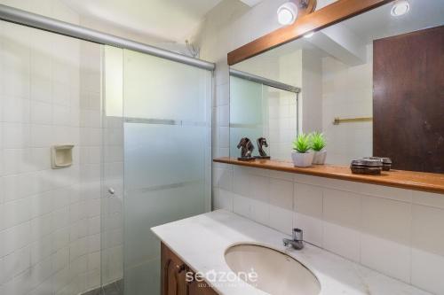 a bathroom with a sink and a mirror at 1-Bedroom Apt in Blumenau SPN0102 in Blumenau