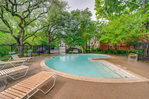 a swimming pool with two benches and trees at 1 Bedroom apt w Swimming Pool Wifi Parking In Dallas TX in Dallas