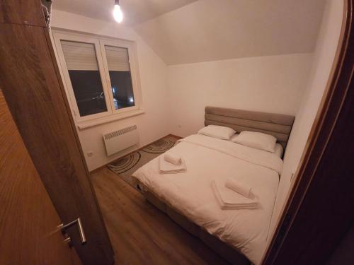 a small bedroom with a bed and a window at Mali Princip in Pale