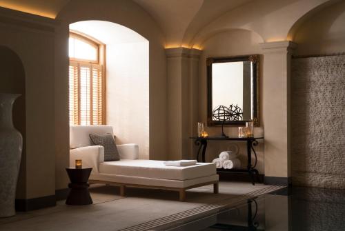 a living room with a white couch and a mirror at Four Seasons Hotel Prague in Prague