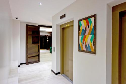 a hallway with a painting hanging on a wall at 37GS Residences in London