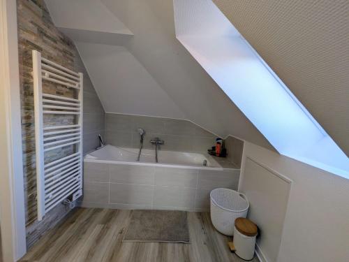 a bathroom with a bath tub in a attic at Escale Im Elsass in Mutzig