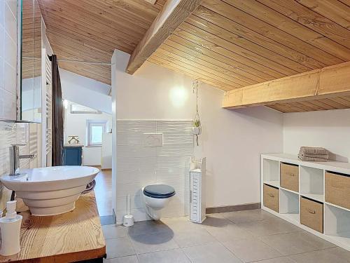 a large bathroom with a tub and a toilet at Coeur de pierre in Vallon-Pont-dʼArc