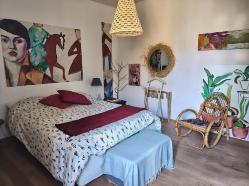 a bedroom with a bed and a chair at La Campana in Impruneta