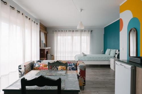 a living room with a couch and a table at A Praia, My Own Paradise- Estúdio in Figueira da Foz