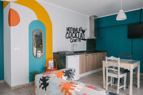 a kitchen with a table and a dining room at A Praia, My Own Paradise- Estúdio in Figueira da Foz