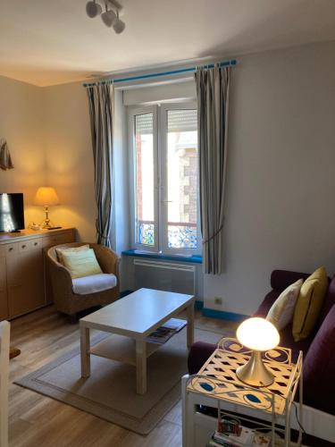 a living room with a couch and a table at Morbreizh 1 in Paimpol
