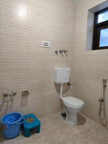 a bathroom with a toilet and a shower stall at Hotel Sada Bahar in Srinagar