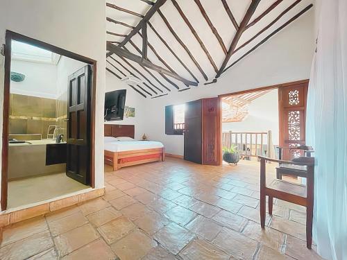 a bedroom with a bed and a sink in a room at Casa Real Barichara in Barichara