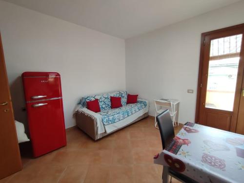 a living room with a couch and a red refrigerator at Da Luca in Càbras