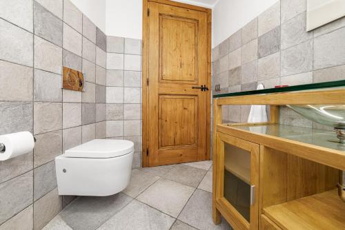 a bathroom with a toilet and a sink at Maison Carrel Elegant 1 in Breuil-Cervinia