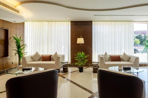 a living room with couches and tables and windows at Imperial - إمبريال in Riyadh