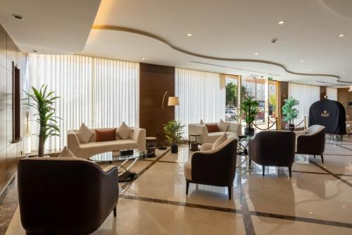 a lobby with couches and tables and chairs at Imperial - إمبريال in Riyadh