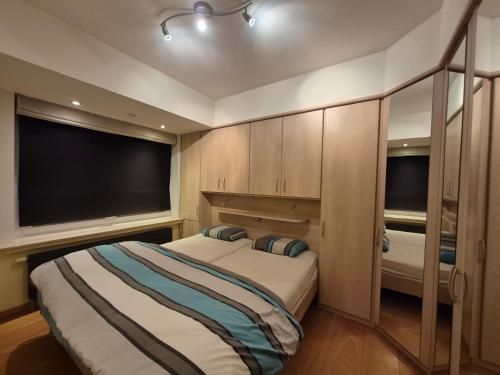 a bedroom with two beds and a large tv at Faro in Blankenberge