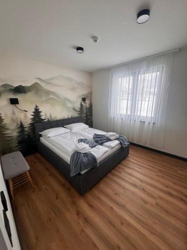 a bedroom with a bed with a painting on the wall at Cabana Aurora in Topliţa