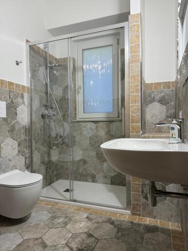 a bathroom with a shower and a sink and a toilet at Casa Gallo in Cala Gonone