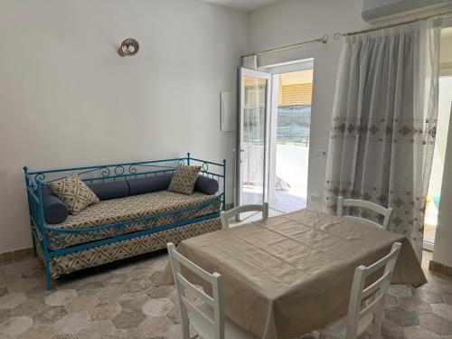 a living room with a bed and a couch at Casa Gallo in Cala Gonone