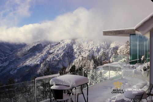 a balcony with snow covered chairs and a mountain at Casa de São Lourenço - Burel Panorama Hotel - member of Relais & Châteaux in Manteigas