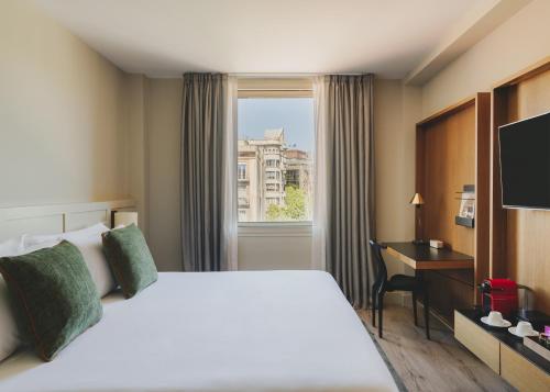 a hotel room with a bed and a window at Catalonia Boulevard 4 Sup in Barcelona