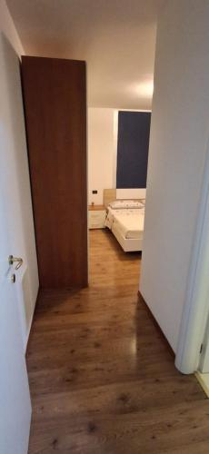 a room with a bedroom with a bed and a door at Chiara Apartment in Cervignano with 2 Double Beds in Cervignano del Friuli