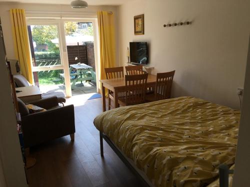 a bedroom with a bed and a table and chairs at The River Flat in Oxford