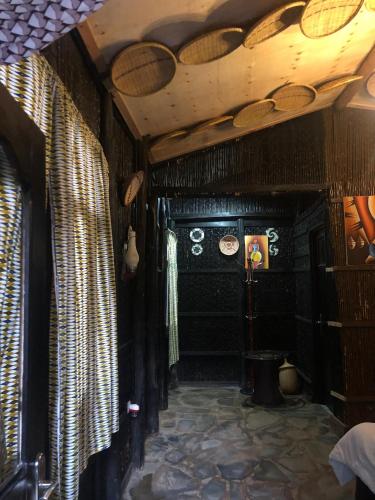 a room with black walls and a ceiling with curtains at NYUNGWE ECOLODGE - Gisakura in Nyamasheke