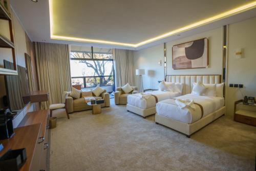 a large hotel room with two beds and a couch at فندق شادن الفخامة in Taif