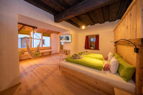 a bedroom with a green bed in a room at Schloss Saalhof- Schlossflair, Wellnessauszeit, Bauernhofleben, Familienzeit im historischen Apartment zentral zwischen Zell am See und Saalbach-Hinterglemm in Maishofen