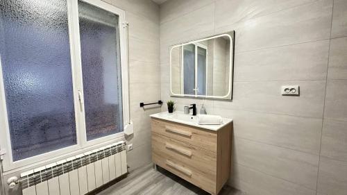 a bathroom with a sink and a window at Habitaciones en Don Ramon in Madrid