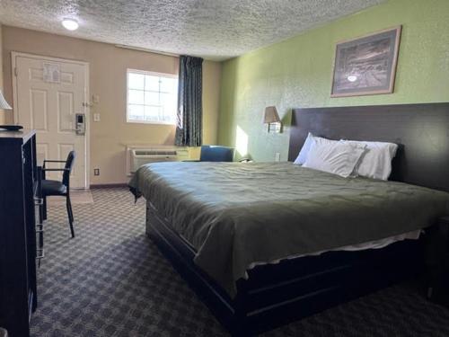 a hotel room with a bed and a desk at Deerfield inn & Suits in Smyrna