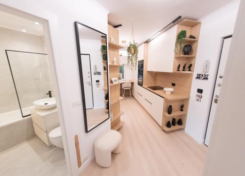 a bathroom with a toilet and a sink at Wabi Sabi Nest in Timişoara