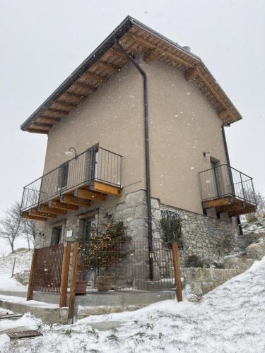 a building with two balconies on it in the snow at Naš duam in Stregna