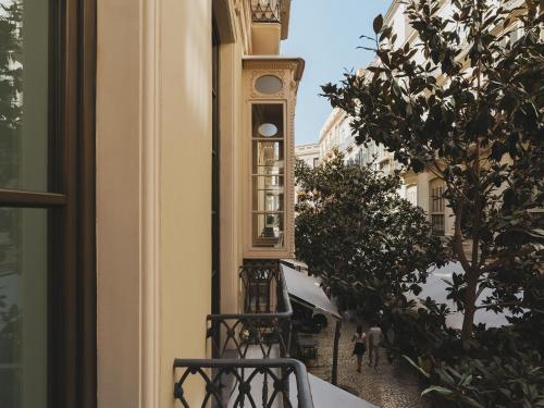 a balcony with chairs and a clock in a building at Catalonia Molina Lario in Málaga