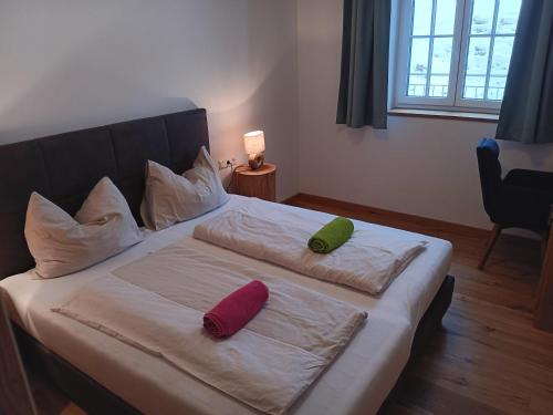 two pillows on a bed in a room at Top 103 Lärchenhof in Mauterndorf