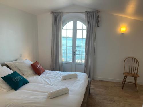 a bedroom with a bed with two pillows on it at Exceptional Waterfront Villa in Hyères