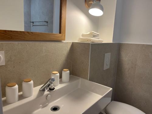 a bathroom with a sink and a toilet and a mirror at Exceptional Waterfront Villa in Hyères
