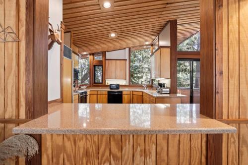 a kitchen with wooden cabinets and a large counter top at Idyllwild Realty Vacations in Idyllwild