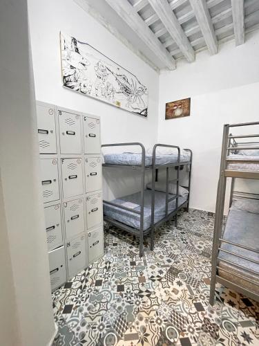 a bedroom with a bunk bed and filing cabinets at Rosa de los Vientos in Cádiz