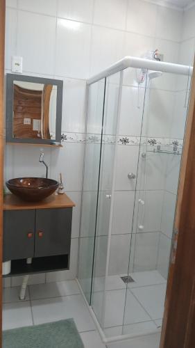 a bathroom with a shower and a sink at Suíte 77 privativa , há 11km da vila germânica in Blumenau