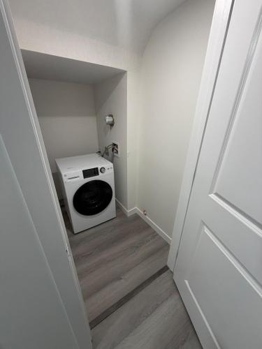 a laundry room with a washer and dryer at Brand New 1 Bedroom Basement Suite in Southwest in Edmonton