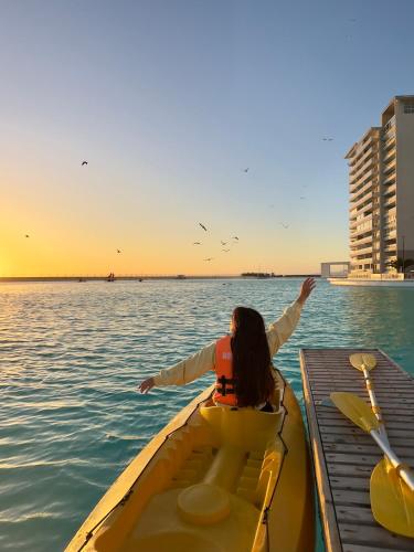 a woman in a boat on the water at Departamentos Laguna del Mar in La Serena