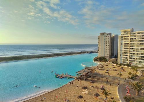 an aerial view of a swimming pool next to the beach at Departamentos Laguna del Mar in La Serena