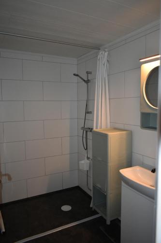 a bathroom with a sink and a toilet and a shower at Villa Frida in Kilen