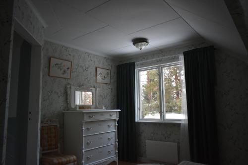a bedroom with a dresser and a window at Villa Frida in Kilen