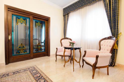 a dining room table and chairs in a room at Grand Hotel President in Olbia